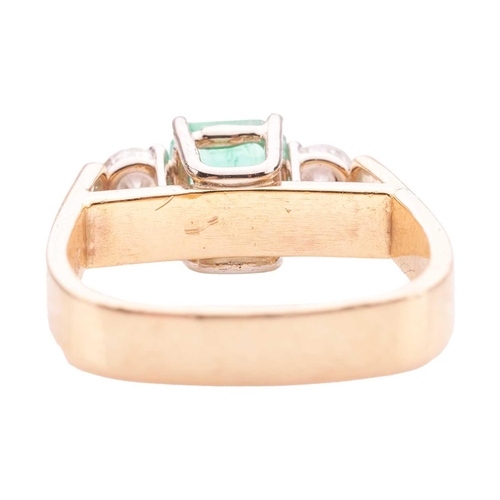 19 - A modern emerald and diamond trilogy ring, comprising a step-cut emerald with canted corners, of bri... 