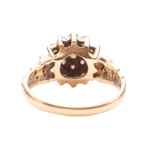 190 - A Modernist-style diamond cluster ring in 18ct gold, set with nineteen round brilliant-cut diamonds,... 