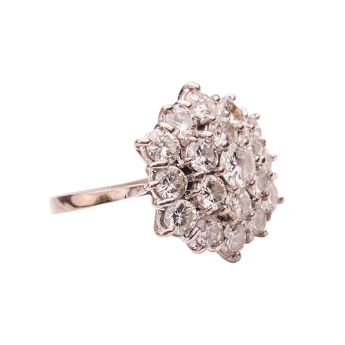 200 - A diamond-set floral cluster ring, featuring nineteen round brilliant diamonds, with an estimated to... 