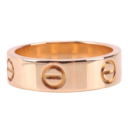 202 - Cartier - a 'Love' ring, flat polished band decorated with screw-head motifs, signed and numbered, s... 