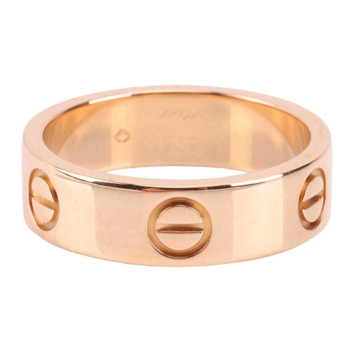 202 - Cartier - a 'Love' ring, flat polished band decorated with screw-head motifs, signed and numbered, s... 