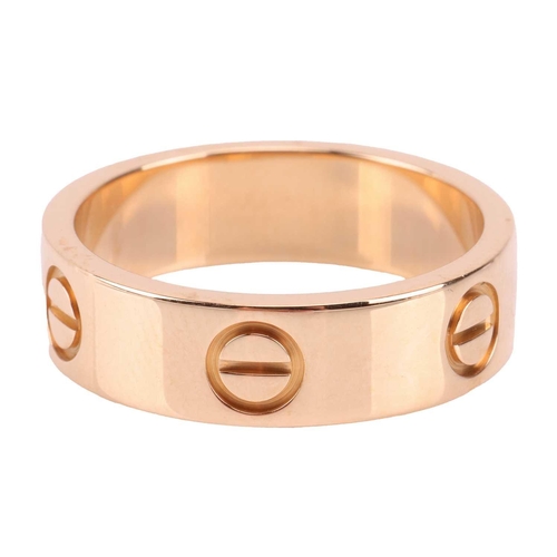 202 - Cartier - a 'Love' ring, flat polished band decorated with screw-head motifs, signed and numbered, s... 