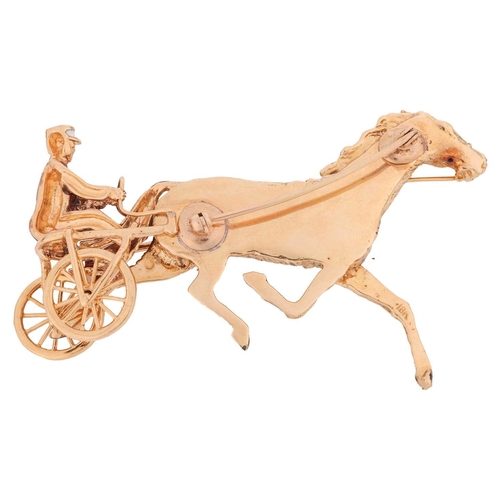 204 - An enamel harness horse racing brooch, the racing sulky with revolving wheels, partially adorned wit... 