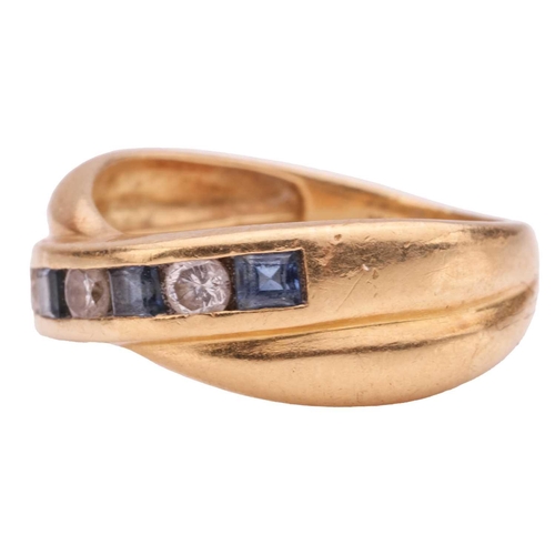 214 - A sapphire and diamond crossover ring, channel-set with alternating square table-cut sapphire and br... 