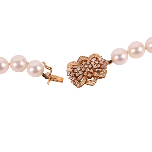 228 - A long cultured pearl necklace with diamond-set clasp, the uniform-size round pearls each measure 9.... 