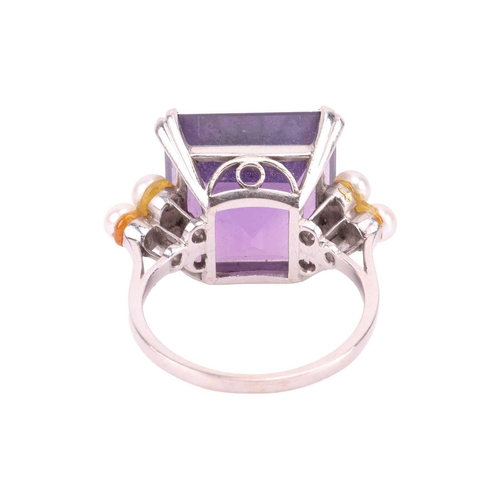 239 - An amethyst and seed pearl dress ring, featuring a step-cut amethyst of 14.0 x 13.2 mm, flanked by t... 