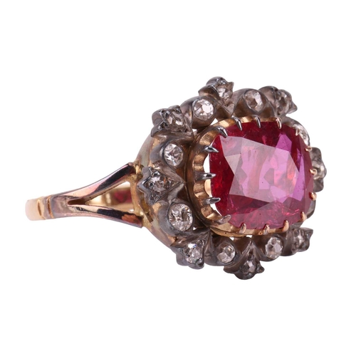 247 - A ruby and diamond cluster ring, centred with an oval-cut ruby of 9.5 x 8.2 x 3.3 mm, within a frame... 