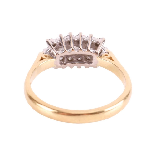 25 - A diamond-set dress ring, claw-set with three princess-cut diamonds surrounded by fourteen round bri... 