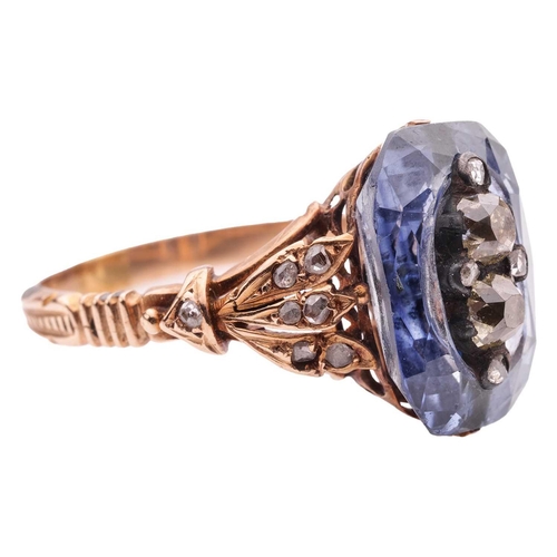 260 - A sapphire and diamond dress ring, featuring a centrally carved cushion-cut sapphire of 13.6 x 9.5 m... 