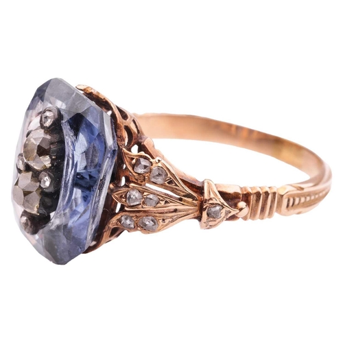 260 - A sapphire and diamond dress ring, featuring a centrally carved cushion-cut sapphire of 13.6 x 9.5 m... 