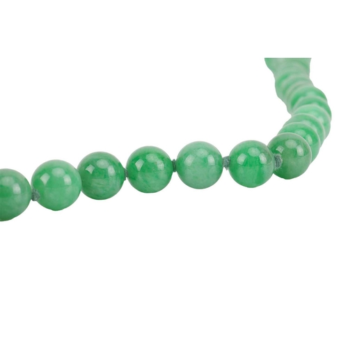 262 - A jade bead necklace with emerald and diamond clasp, circa 1920s, comprising a single row of 108 uni... 