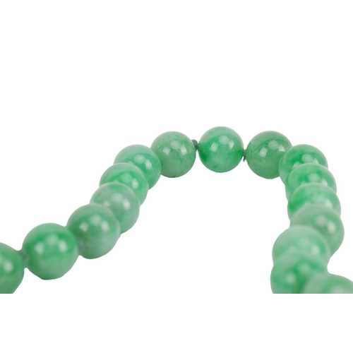 262 - A jade bead necklace with emerald and diamond clasp, circa 1920s, comprising a single row of 108 uni... 