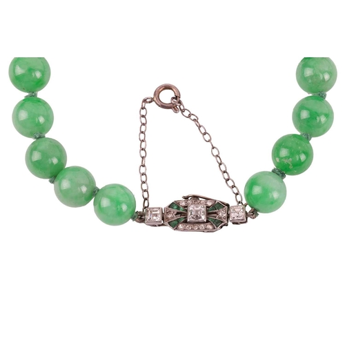 262 - A jade bead necklace with emerald and diamond clasp, circa 1920s, comprising a single row of 108 uni... 