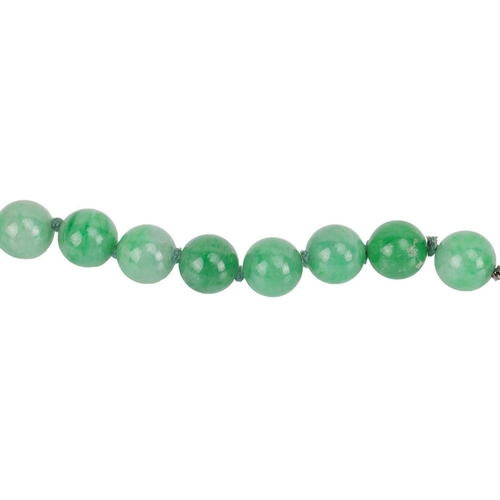 262 - A jade bead necklace with emerald and diamond clasp, circa 1920s, comprising a single row of 108 uni... 