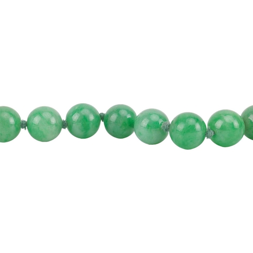 262 - A jade bead necklace with emerald and diamond clasp, circa 1920s, comprising a single row of 108 uni... 