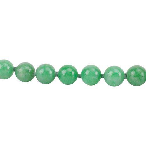 262 - A jade bead necklace with emerald and diamond clasp, circa 1920s, comprising a single row of 108 uni... 