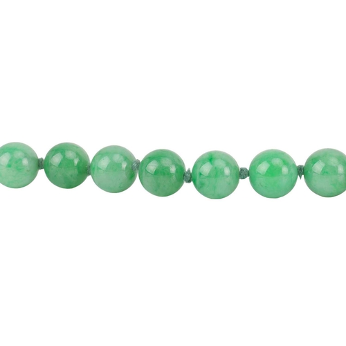 262 - A jade bead necklace with emerald and diamond clasp, circa 1920s, comprising a single row of 108 uni... 