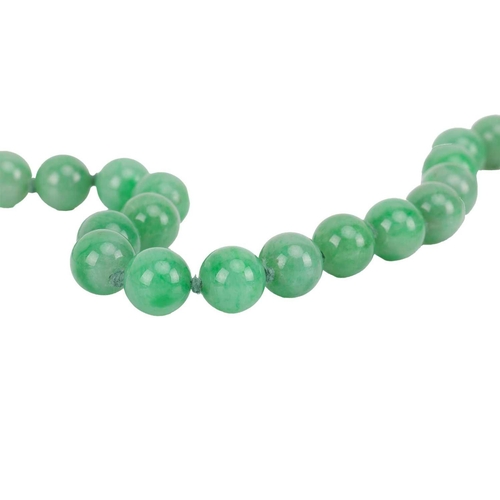 262 - A jade bead necklace with emerald and diamond clasp, circa 1920s, comprising a single row of 108 uni... 