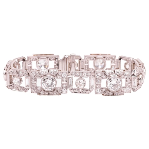 267 - An Art Deco diamond link bracelet, angular links alternating with old-cut diamonds and flanked by ba... 