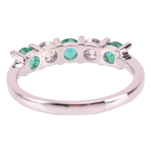 29 - An emerald and diamond-set half-hoop ring, featuring five alternating emeralds and diamonds, measuri... 