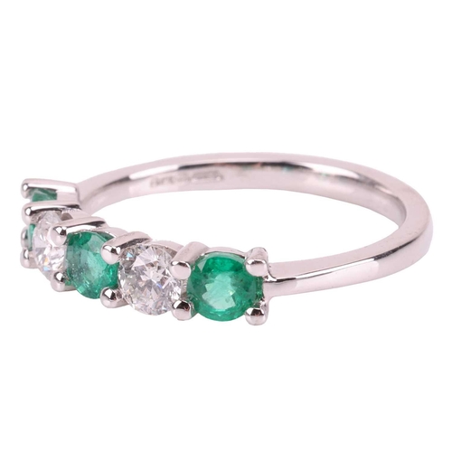 29 - An emerald and diamond-set half-hoop ring, featuring five alternating emeralds and diamonds, measuri... 