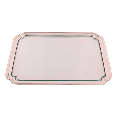 333 - A silver tray with glass liner, rectangular with incuse corners and shaped bracket feet; with plain ... 