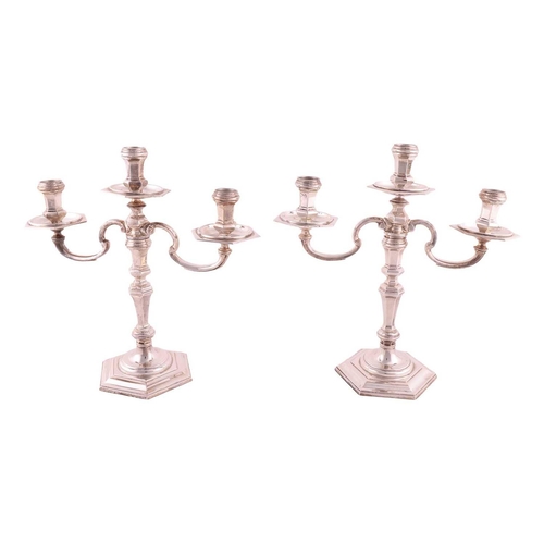 352 - A pair of early 18th century style three light candelabra; panelled hexagonal form with detachable s... 