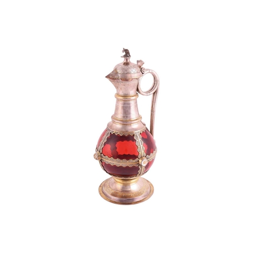 356 - A Victorian silver-mounted ruby glass communion wine jug. The bulbous plain glass body overlaid with... 