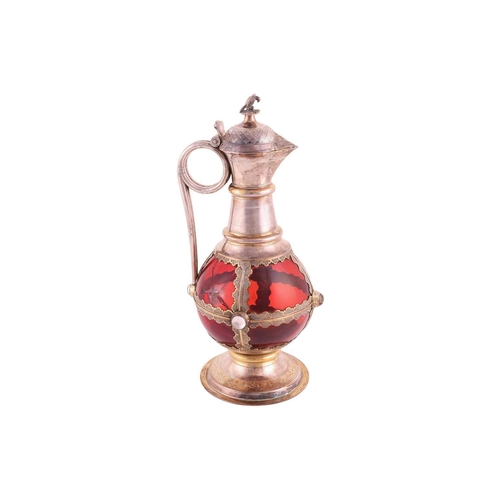 356 - A Victorian silver-mounted ruby glass communion wine jug. The bulbous plain glass body overlaid with... 