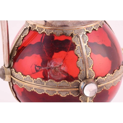 356 - A Victorian silver-mounted ruby glass communion wine jug. The bulbous plain glass body overlaid with... 