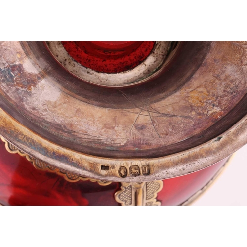 356 - A Victorian silver-mounted ruby glass communion wine jug. The bulbous plain glass body overlaid with... 