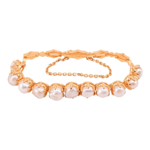 39A - A pearl-set line bracelet, comprising a row of eleven off-rounded button pearls in hinged mounts, at... 