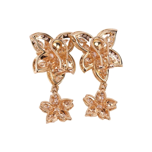 52 - A pair of diamond drop earrings, each pierced flowerhead surmount claw-set throughout with brilliant... 