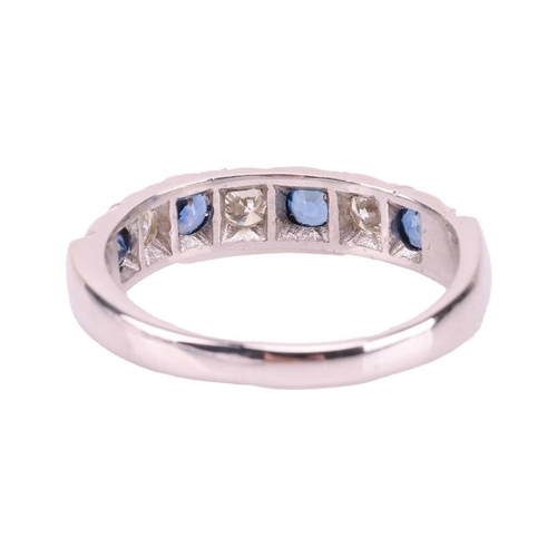 54 - A sapphire and diamond half-eternity ring in 18ct white gold, comprising four circular-cut sapphires... 