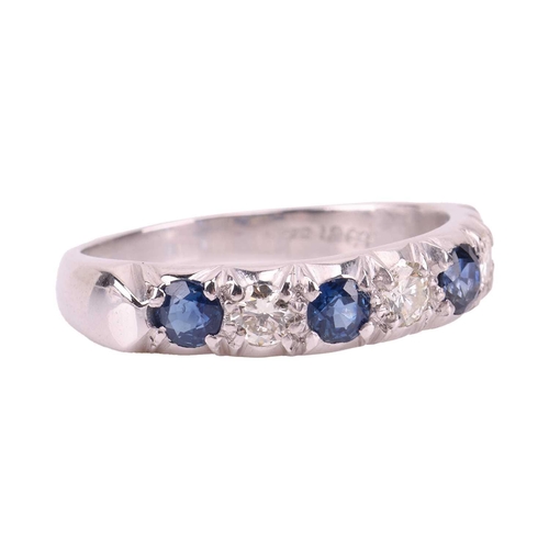 54 - A sapphire and diamond half-eternity ring in 18ct white gold, comprising four circular-cut sapphires... 