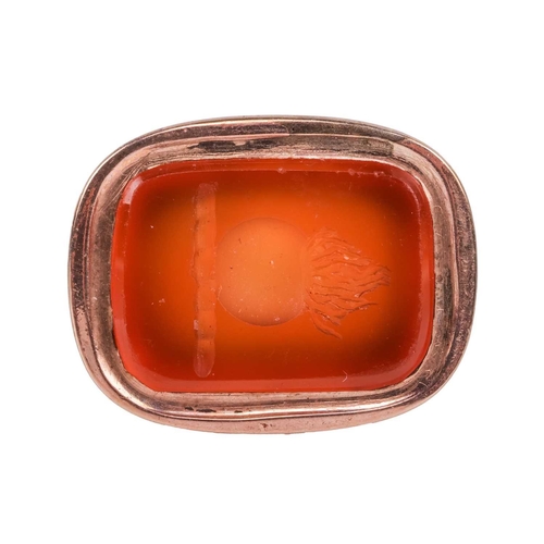 55 - A Victorian carnelian fob seal, of scrollwork design, suspending from a split ring with quilted patt... 