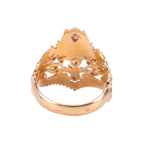 56 - A diamond-set dress ring in 18ct gold, of foliate design, the scrolled openwork mount edged with a g... 