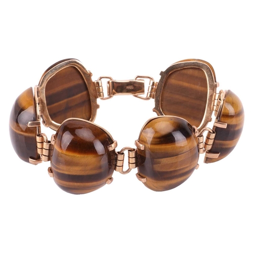 59 - A tiger's eye link bracelet, comprising six large tiger's eye cabochons in claw settings, connected ... 