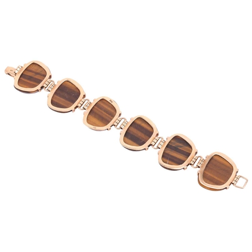 59 - A tiger's eye link bracelet, comprising six large tiger's eye cabochons in claw settings, connected ... 