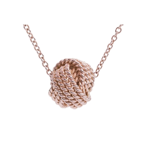 63 - Tiffany & Co. - a twisted knot pendant on chain, suspending on a fine cable link chain with spring-r... 