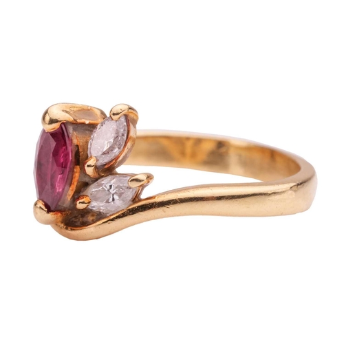 64 - A ruby and diamond dress ring in 18ct gold, of a stylised foliate design, set with a marquise-cut ru... 