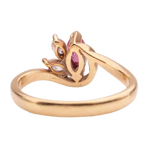 64 - A ruby and diamond dress ring in 18ct gold, of a stylised foliate design, set with a marquise-cut ru... 