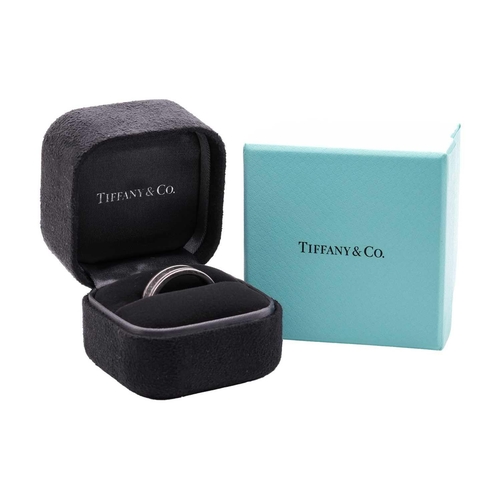 7 - Tiffany & Co. - a wedding band, the flat polished band adorned with corrugated borders, signed and m... 