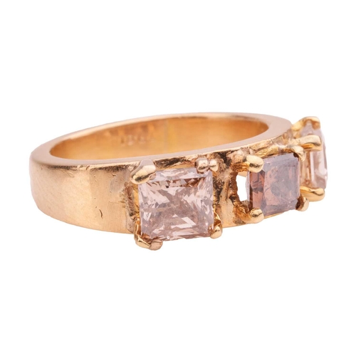 74 - A diamond three-stone ring, comprising three princess-cut brown diamonds in claw settings, with an e... 