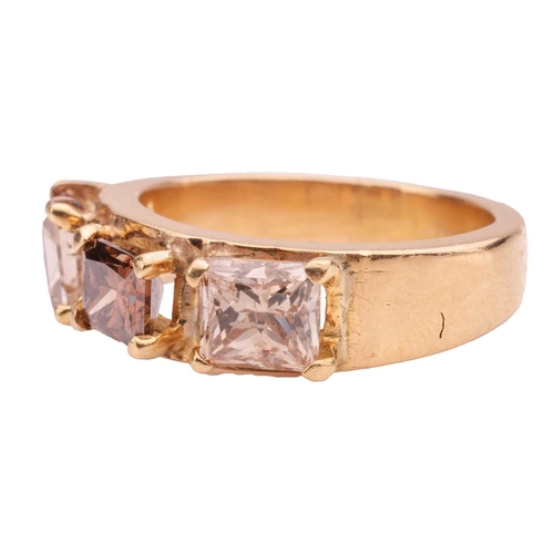 74 - A diamond three-stone ring, comprising three princess-cut brown diamonds in claw settings, with an e... 