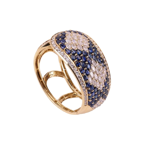 79 - A sapphire and diamond-hinged bangle the tapered plaque decorated throughout with oval-cut sapphires... 