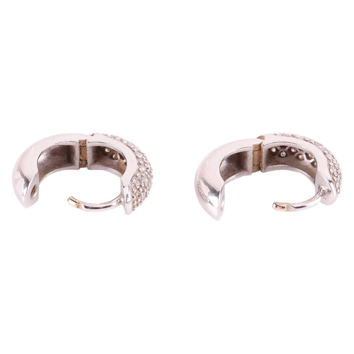 8 - A pair of diamond-set huggy hoop earrings, the front half segment pavé-set with single-cut diamonds,... 