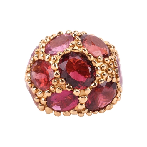 81 - A tourmaline cluster bombé ring/scarf ring of granulated design, composed of nine large oval-cut tou... 