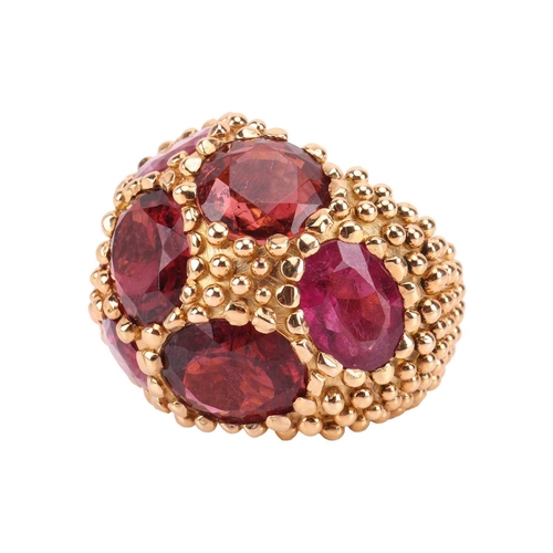 81 - A tourmaline cluster bombé ring/scarf ring of granulated design, composed of nine large oval-cut tou... 