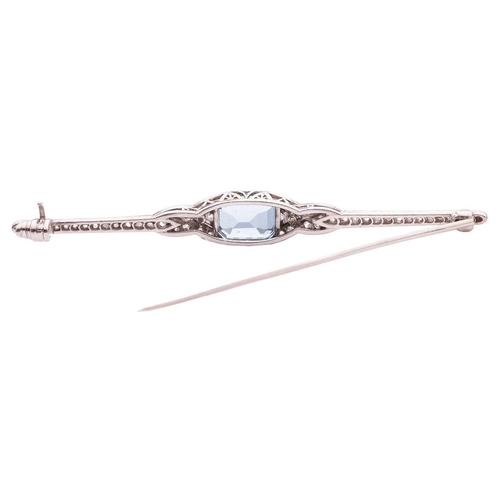 85 - An early 20th-century aquamarine and diamond bar brooch, featuring a step-cut aquamarine with canted... 